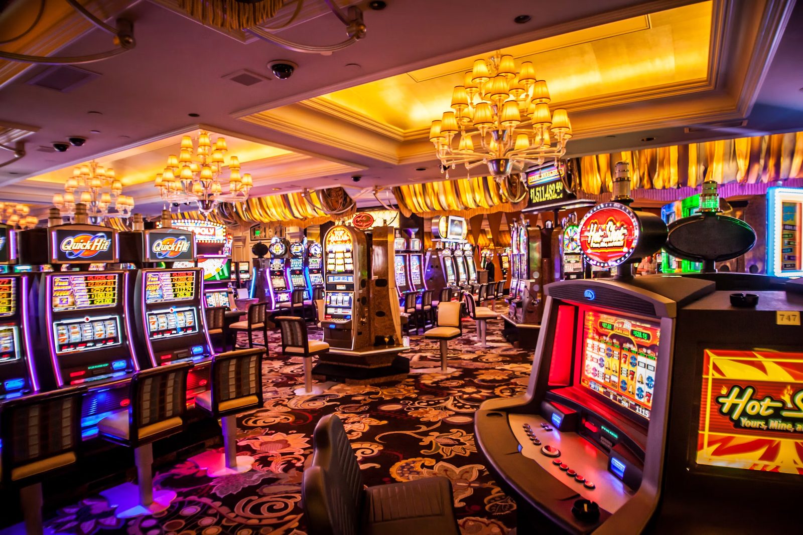 Bright casino floor lined with themed slot machines